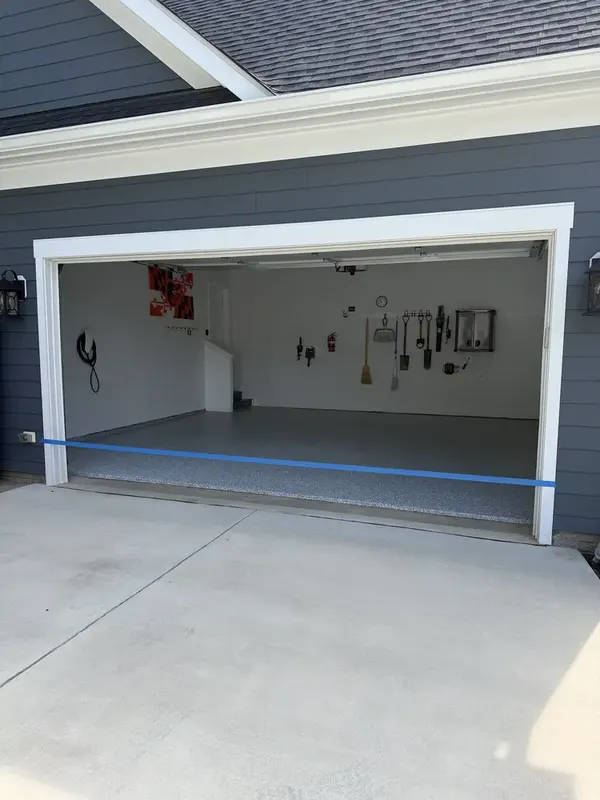 Open two-car garage in Herndon, VA with a freshly coated Gravel flake floor