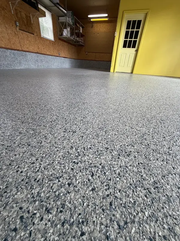 Close-up of blue, grey and white Tidal Wave flakes on an Annandale, VA garage floor