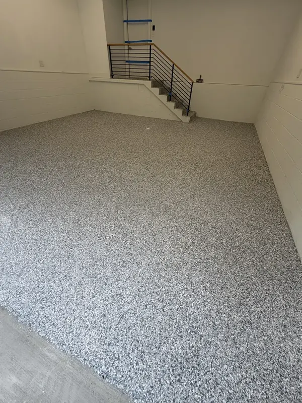 Gravel flake coating running to the back wall and stairs of a Washington, DC garage