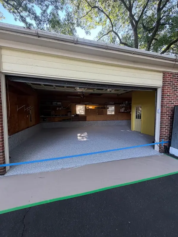 Open garage door in Annandale, VA showing the new Tidal Wave flake floor from the driveway