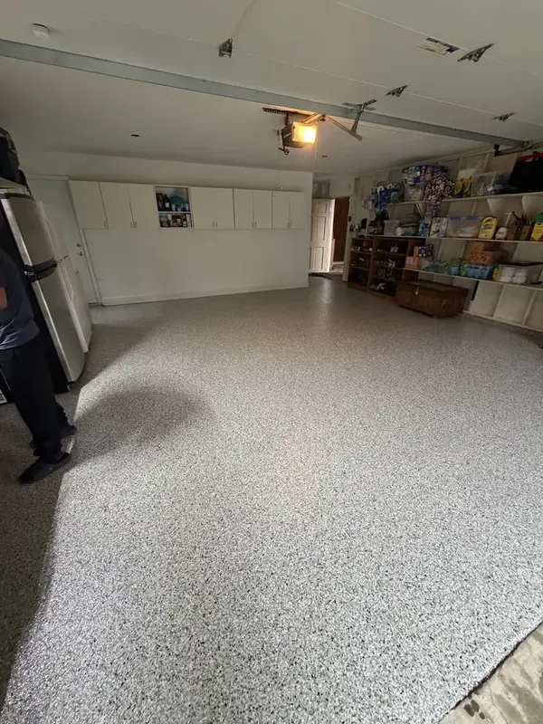 Coyote flake floor running the length of a Potomac, MD garage toward the back shelving