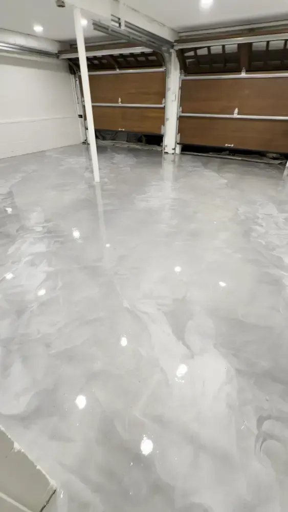 Glossy Dolphin Grey metallic floor reflecting lights in front of wooden garage doors in Chevy Chase, MD