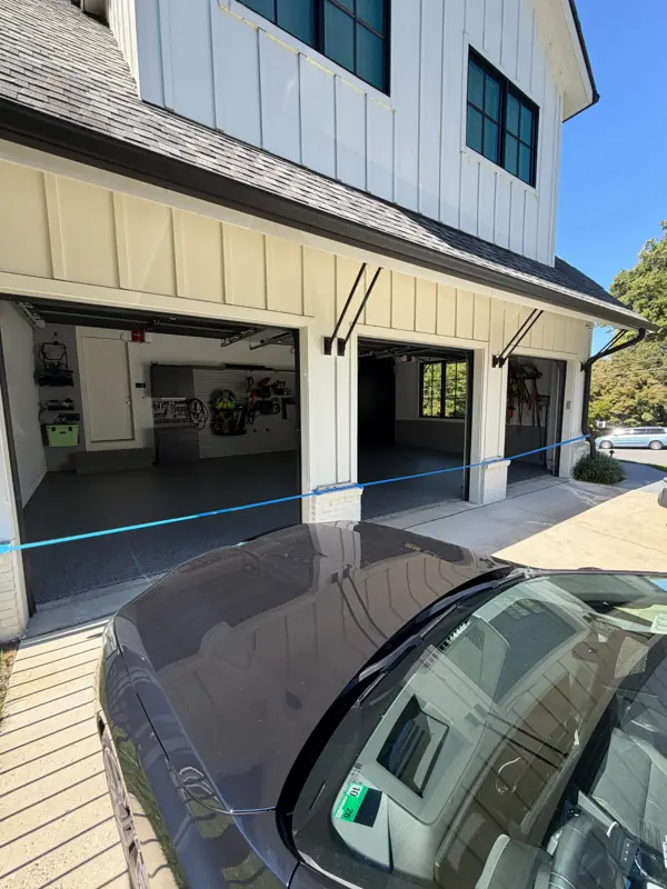 Exterior of a McLean, VA home with three open garage doors showing the new Nightfall flake floors