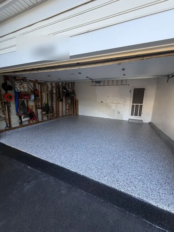Open two-car garage in Silver Spring, MD with a finished Domino flake floor