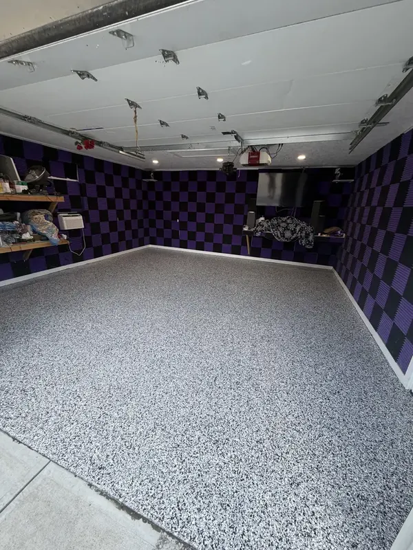 Wide view of the black and white Domino flake floor from the garage entrance in Ashburn, Virginia