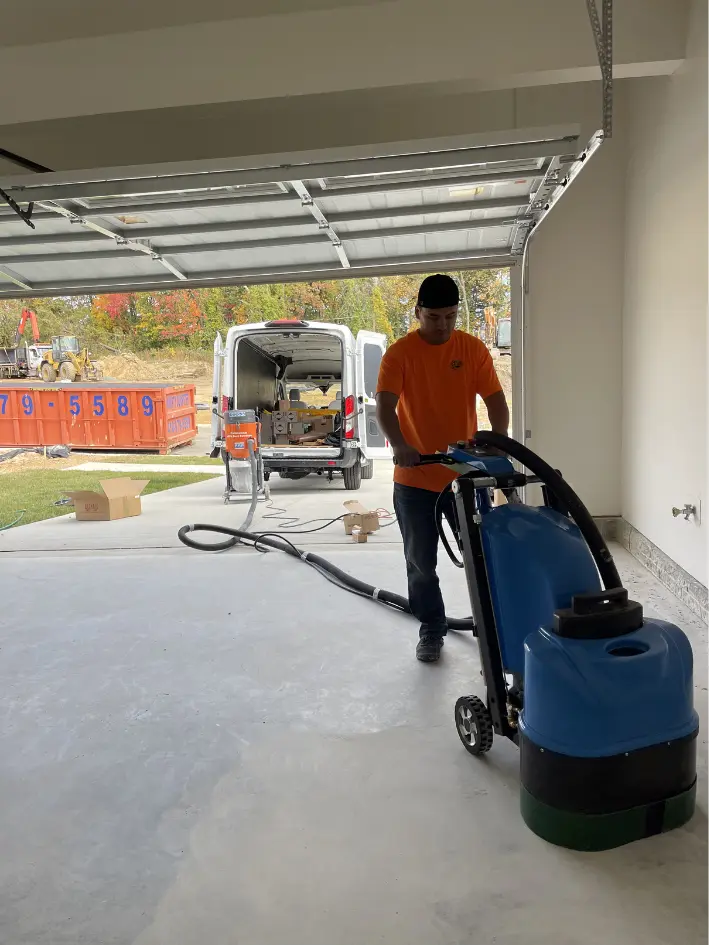 Altangerel Shoovdor grinding a garage floor before coating