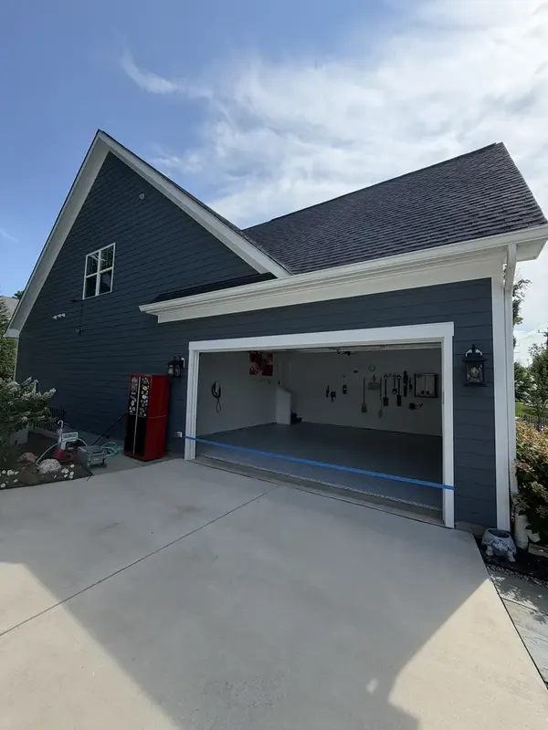 Blue-grey home in Herndon, Virginia with its garage open to show the new Gravel flake floor