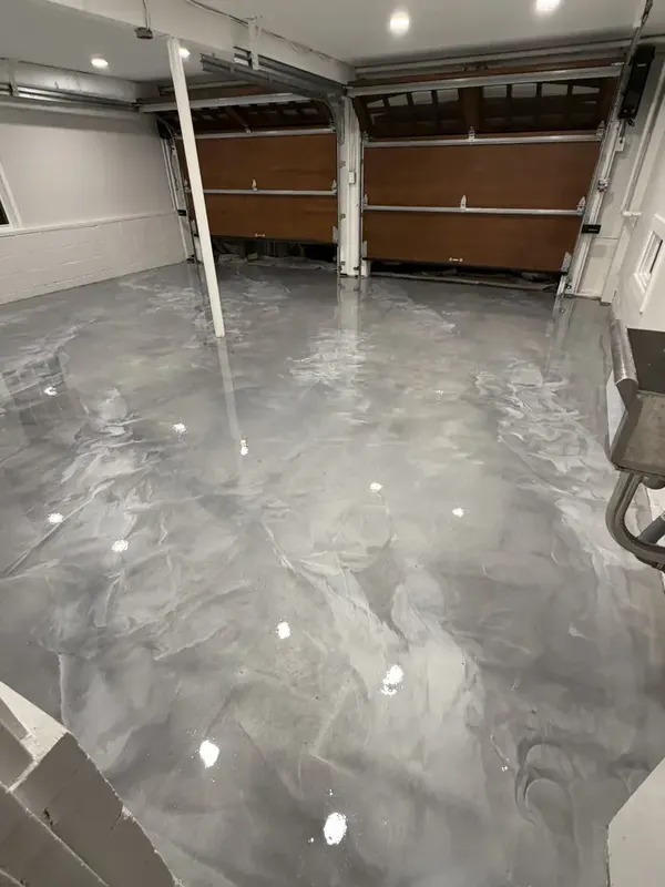Wide view of the reflective Dolphin Grey metallic garage floor in Chevy Chase, Maryland