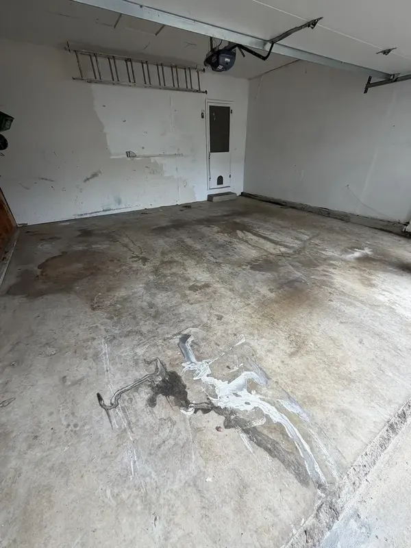 Stained bare concrete in the Silver Spring garage before the floor coating