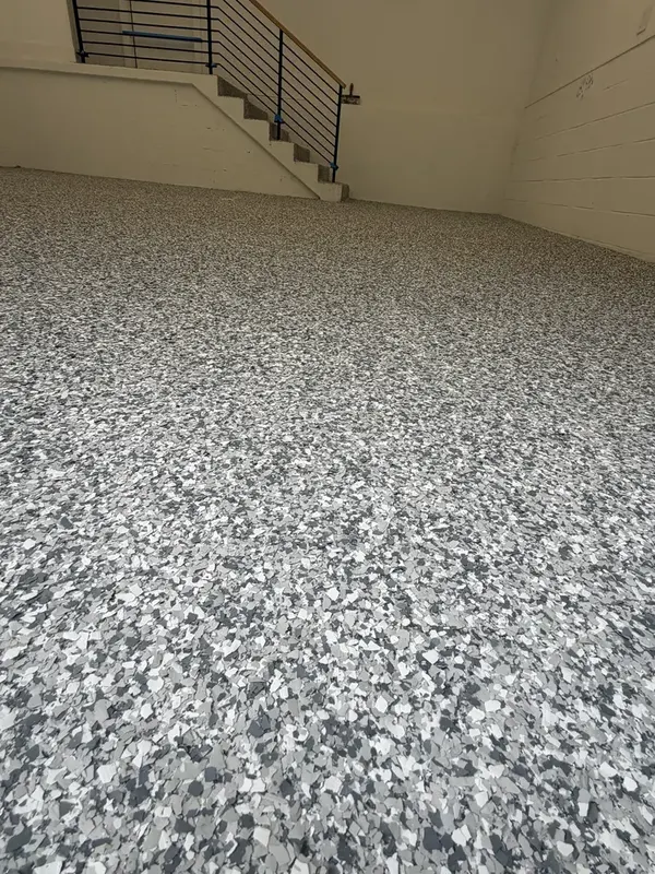 Low-angle close-up of the grey and white Gravel flake texture on a Washington, DC garage floor