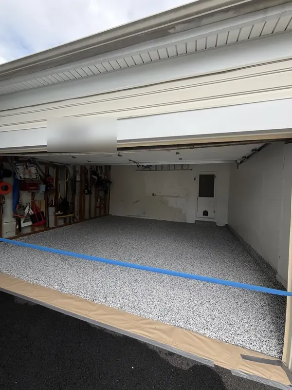 Freshly coated Domino flake floor with tape still at the entrance of a Silver Spring garage
