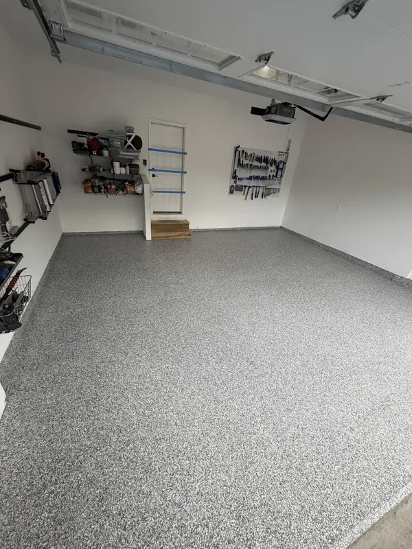 Finished Stonehenge flake floor across a two-car garage in Arlington, VA, seen from the garage door