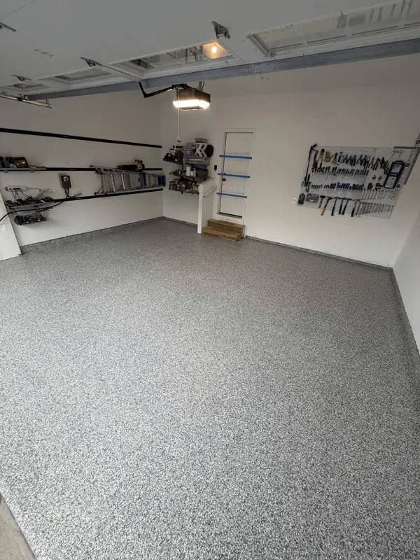 Stonehenge flake garage floor in Arlington, VA with tool racks and wall shelving