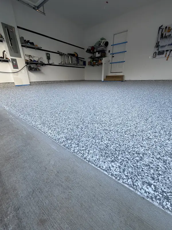 Clean edge where the Stonehenge flake floor meets the concrete apron of an Arlington, VA garage