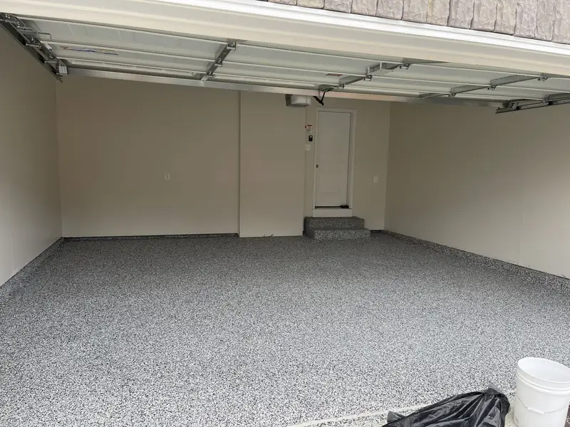 Finished Domino flake floor in a two-car garage in Great Falls, VA, seen from under the open garage door
