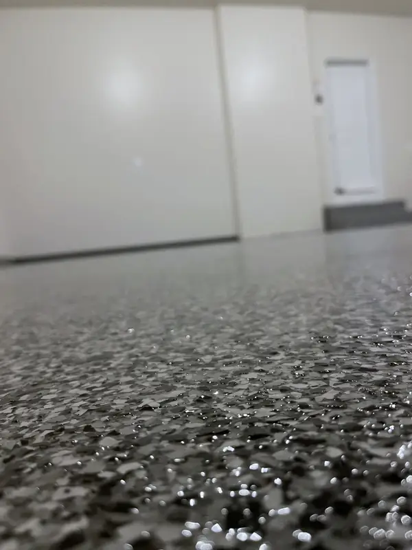 Low close-up of glossy black, grey and white Domino flakes in a Great Falls, VA garage