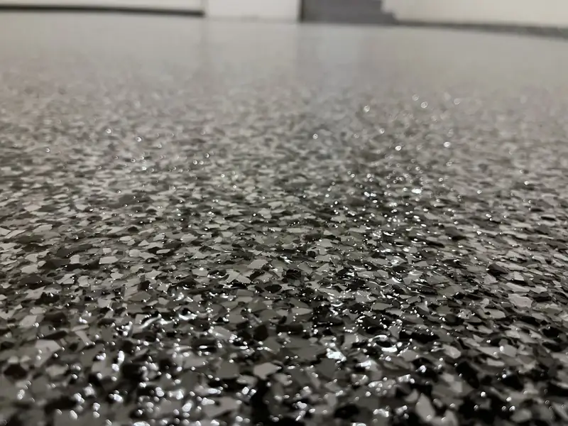Ground-level close-up of the Domino flake texture on a Great Falls, VA garage floor