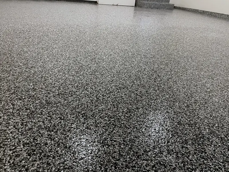 Glossy Domino flake garage floor in Great Falls, VA reflecting the overhead light