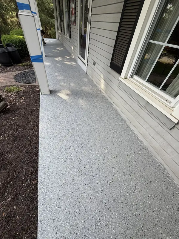 Long covered porch in Herndon, VA finished with a light grey Husky Hybrid flake floor along the house