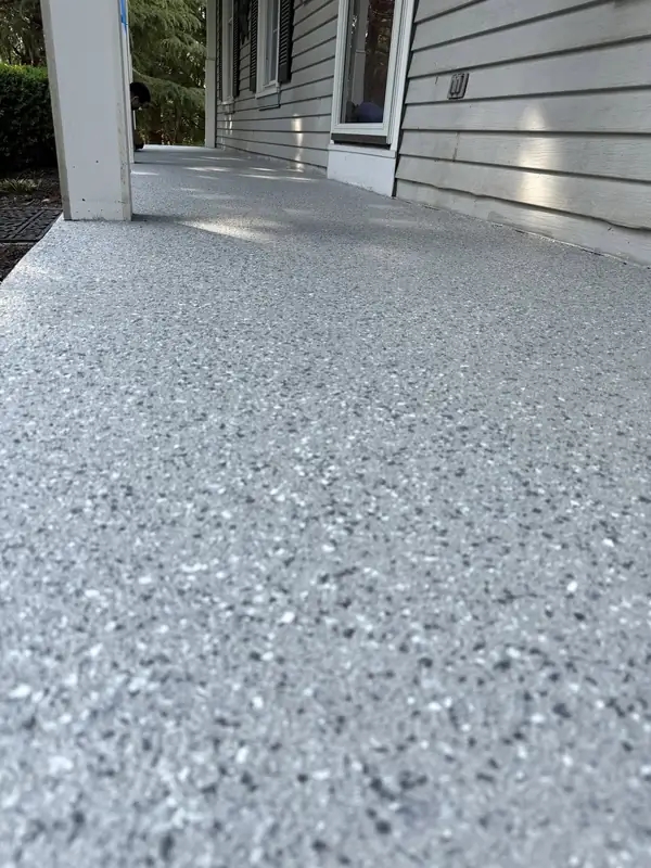 Close-up of the light grey Husky Hybrid flake texture on a Herndon, VA porch floor