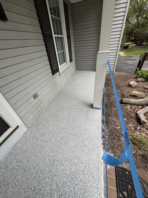 End of a Herndon, VA porch coated in Husky Hybrid flake, beside the garden beds