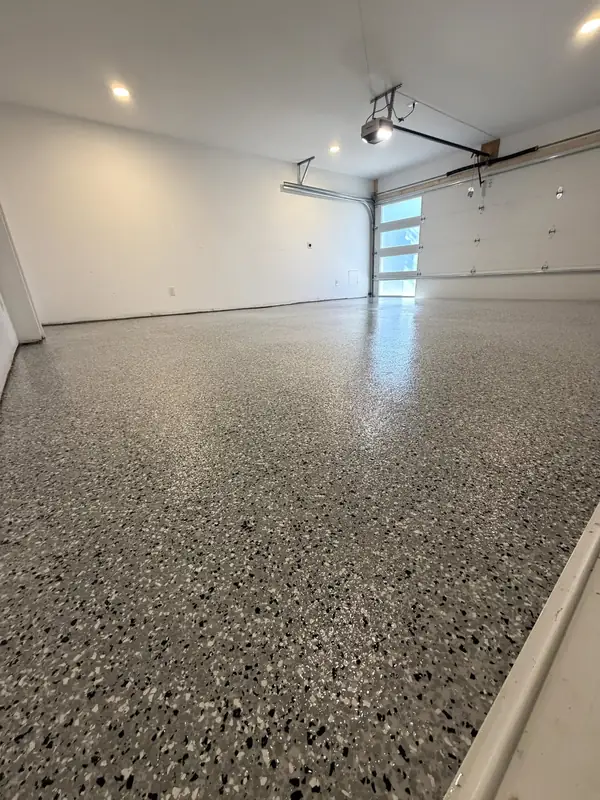 Finished Denali Hybrid flake floor in a bright Washington, DC two-car garage, looking toward the windowed garage door
