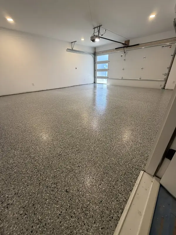 Glossy Denali Hybrid flake garage floor in Washington, DC reflecting the light from the garage door windows