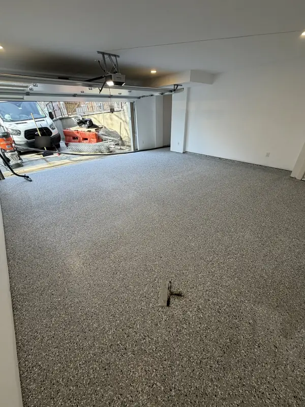 Denali Hybrid flake floor in a Washington, DC garage seen from the back wall, with the overhead door open