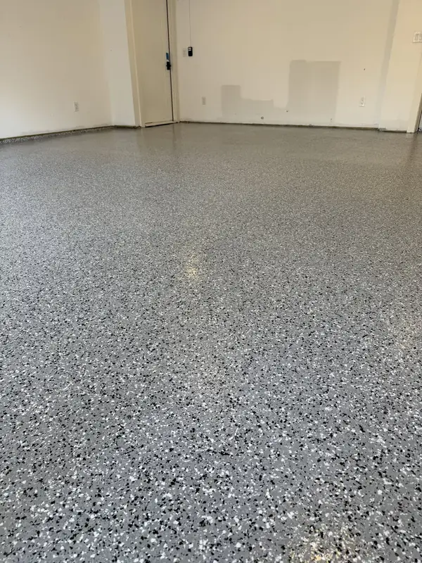Grey, black and white Denali Hybrid flake floor running to the interior door of a Washington, DC garage